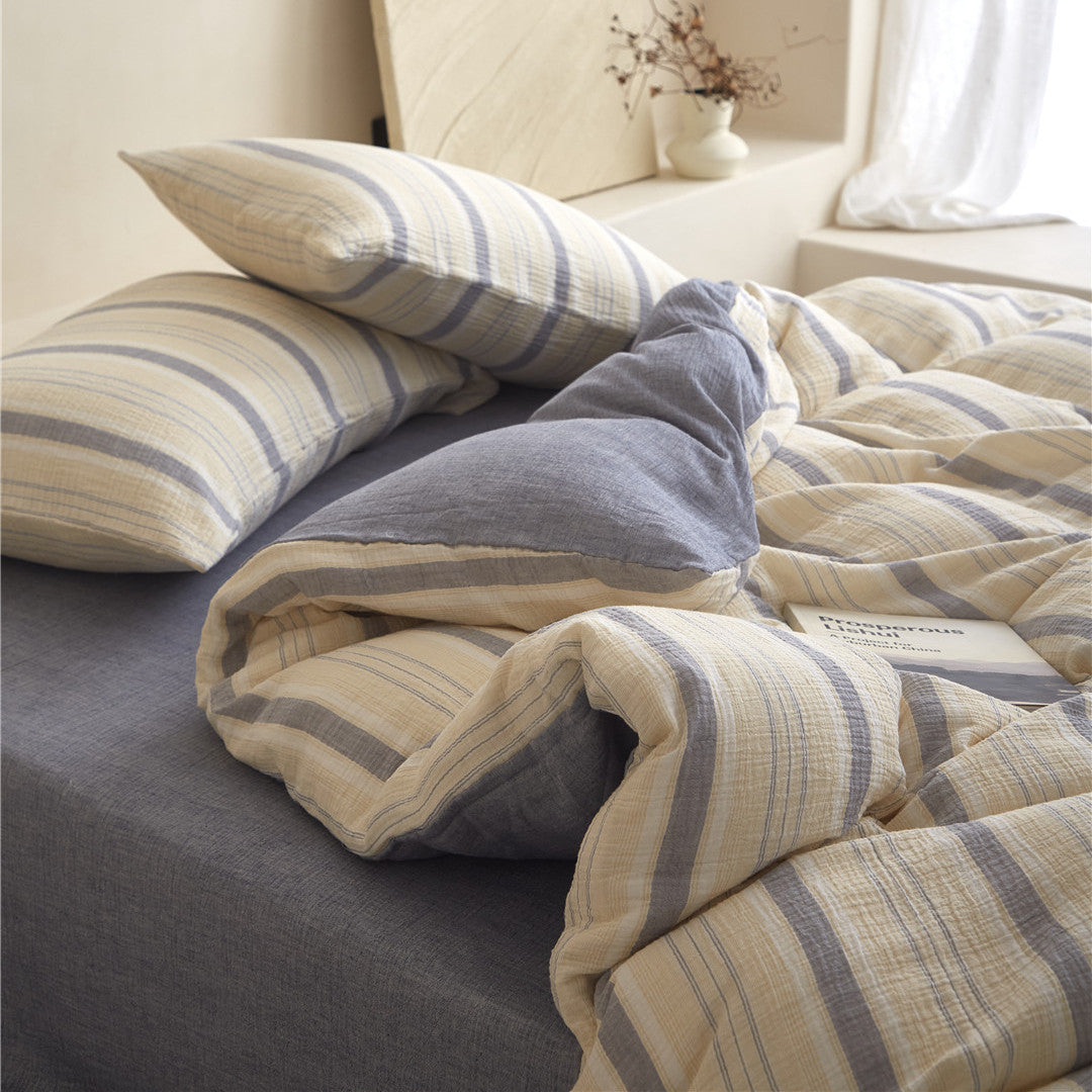 Detailed close-up of the Beige & Grey Stripe duvet cover and shams, highlighting the soft cotton gauze texture.