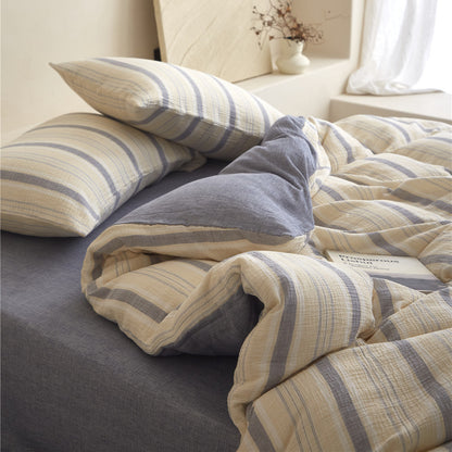 Detailed close-up of the Beige & Grey Stripe duvet cover and shams, highlighting the soft cotton gauze texture.