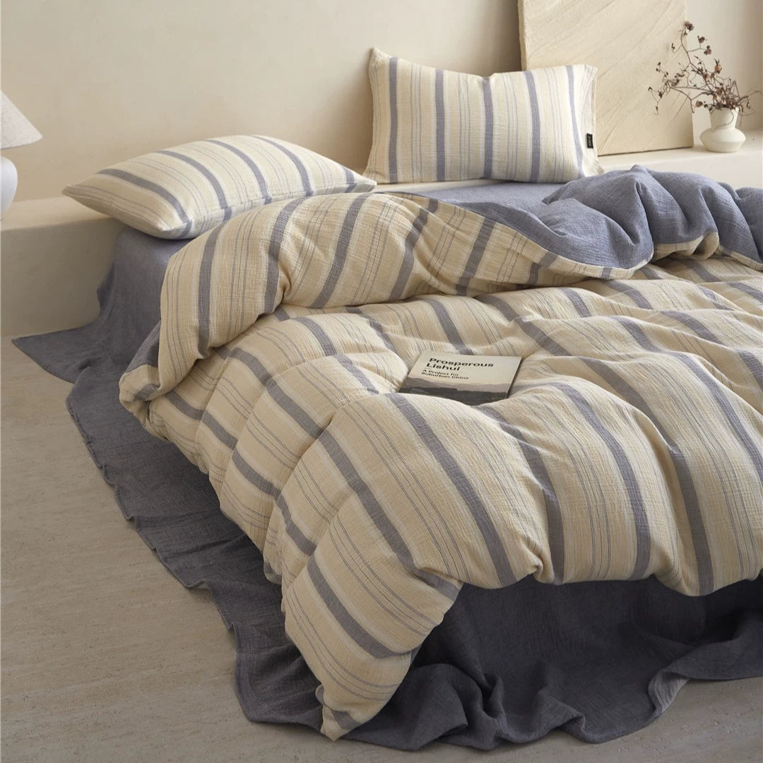 Full-bed styled view of the Beige & Grey Stripe Minimalist Bedding Set, emphasizing the crinkle texture and the matching solid sheet.