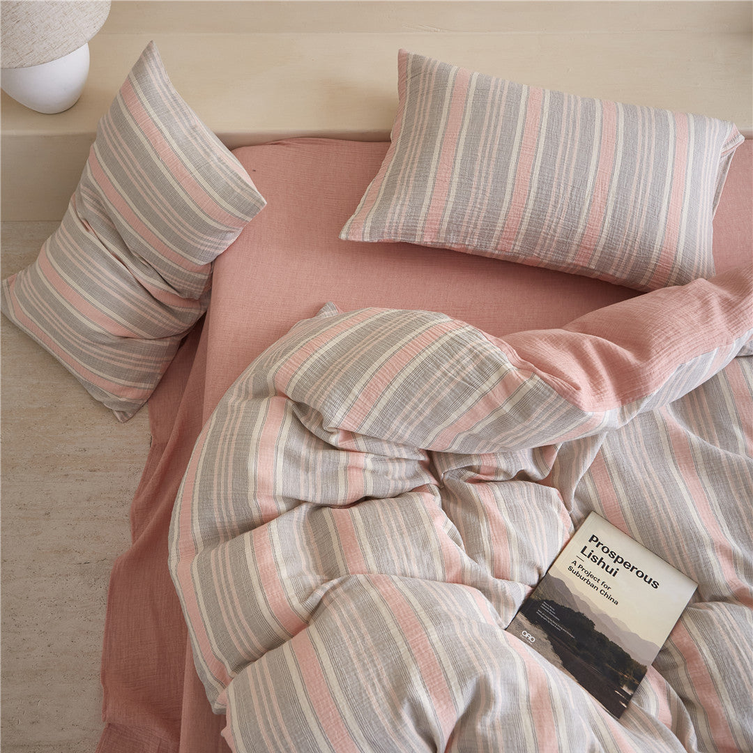 Overhead view of the Grey & Pale Pink Striped Duvet Cover Set, showing the crinkle texture and the solid pink reverse side.