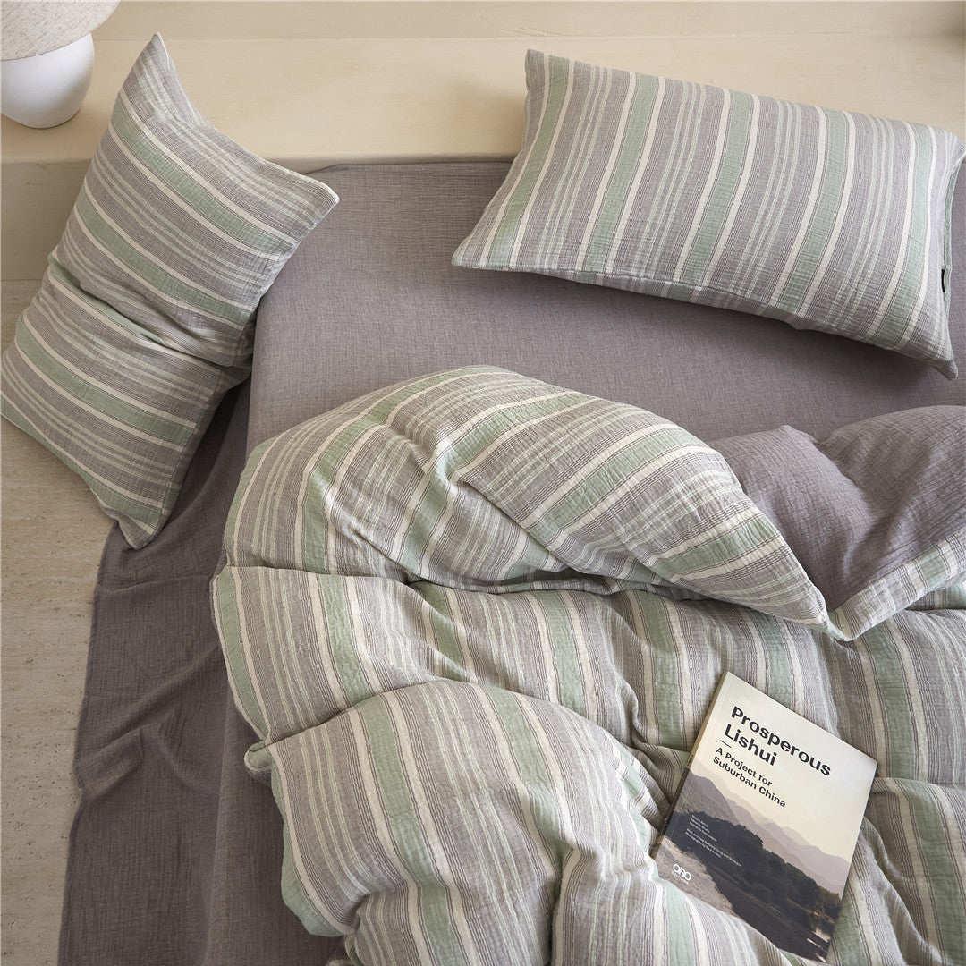 Top-down view of the Grey & Pale Green Striped Duvet Cover Set, highlighting the soft crinkle texture and reversible design.