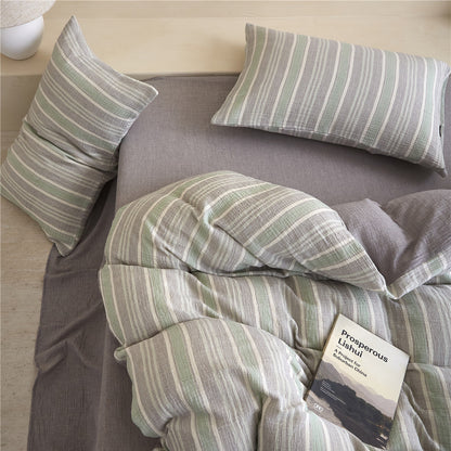 Top-down view of the Grey & Pale Green Striped Duvet Cover Set, highlighting the soft crinkle texture and reversible design.
