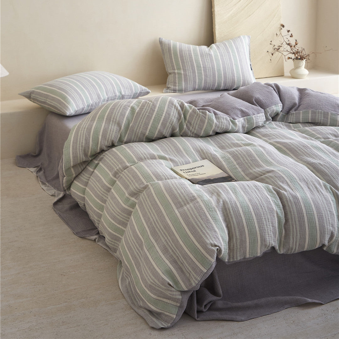 Styled shot of the Grey & Pale Green Bedding Set, emphasizing the soft folds and the solid gray sheet in a bright room.