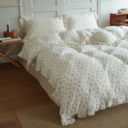 A side-angle view of a full bed with the vintage rose patterned cotton muslin duvet cover set. 