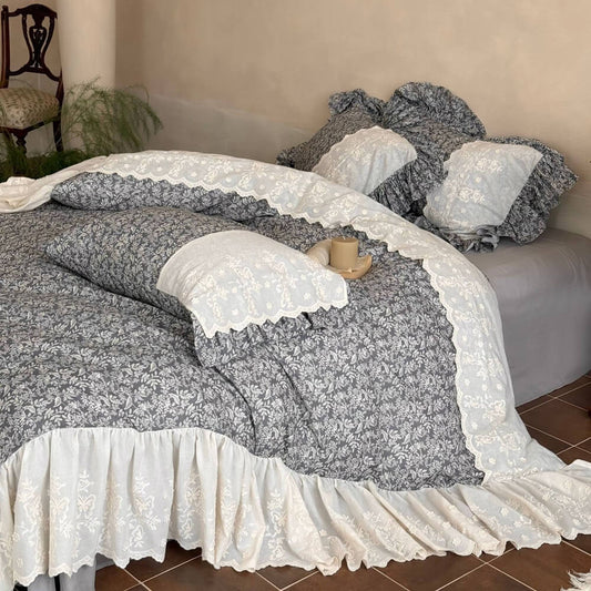 Gray botanical ruffle bedding set with ivory embroidery in a romantic cottage bedroom
