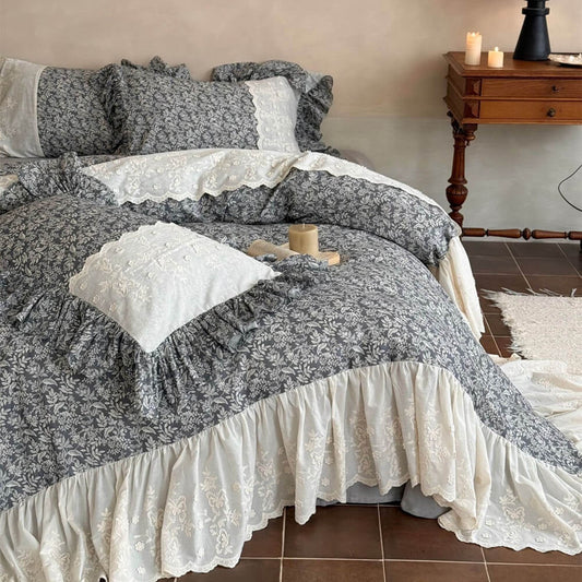 Gray-blue botanical bedding set with ivory ruffled edges and vintage bedside decor
