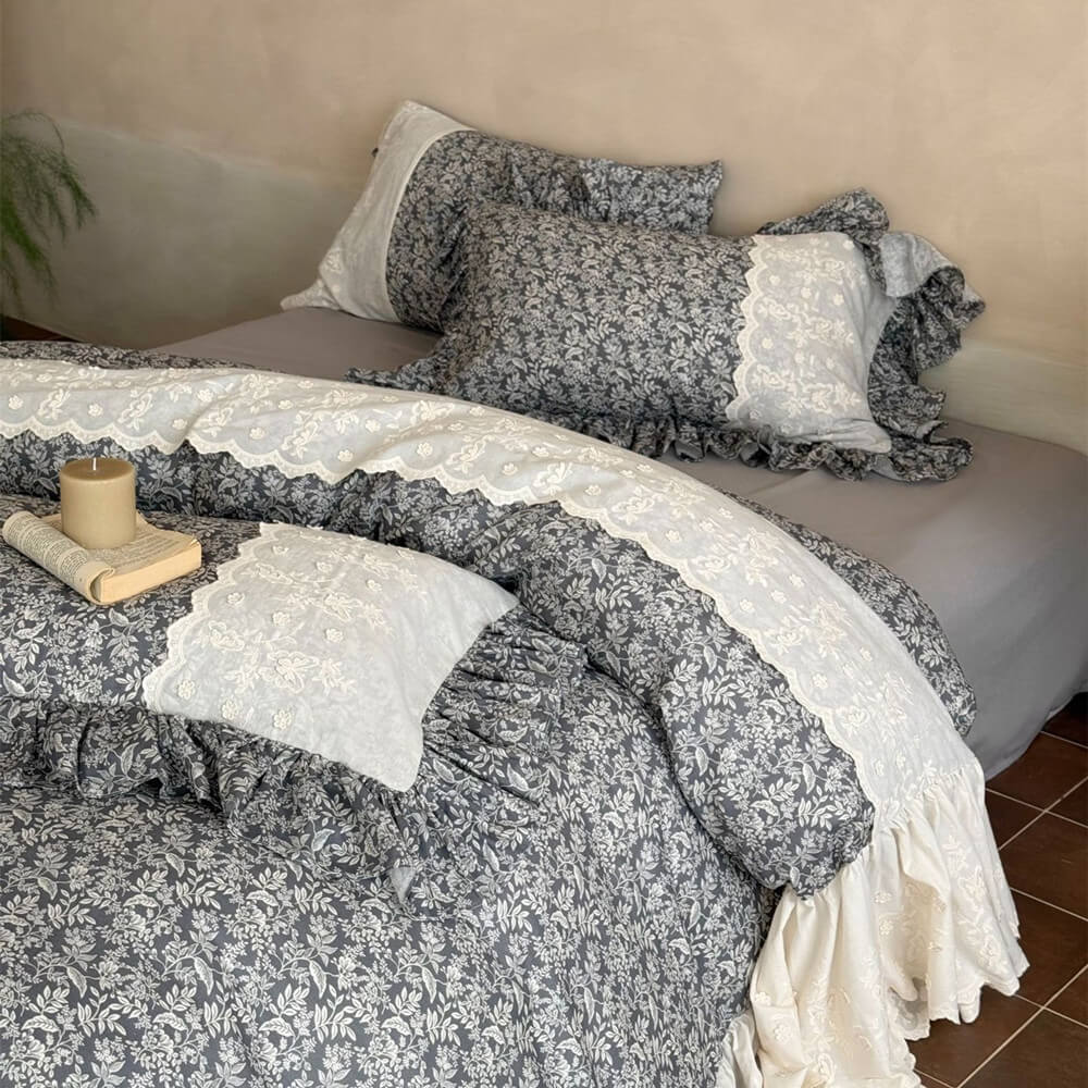 Gray botanical duvet cover with ivory eyelet embroidery and ruffled pillowcases