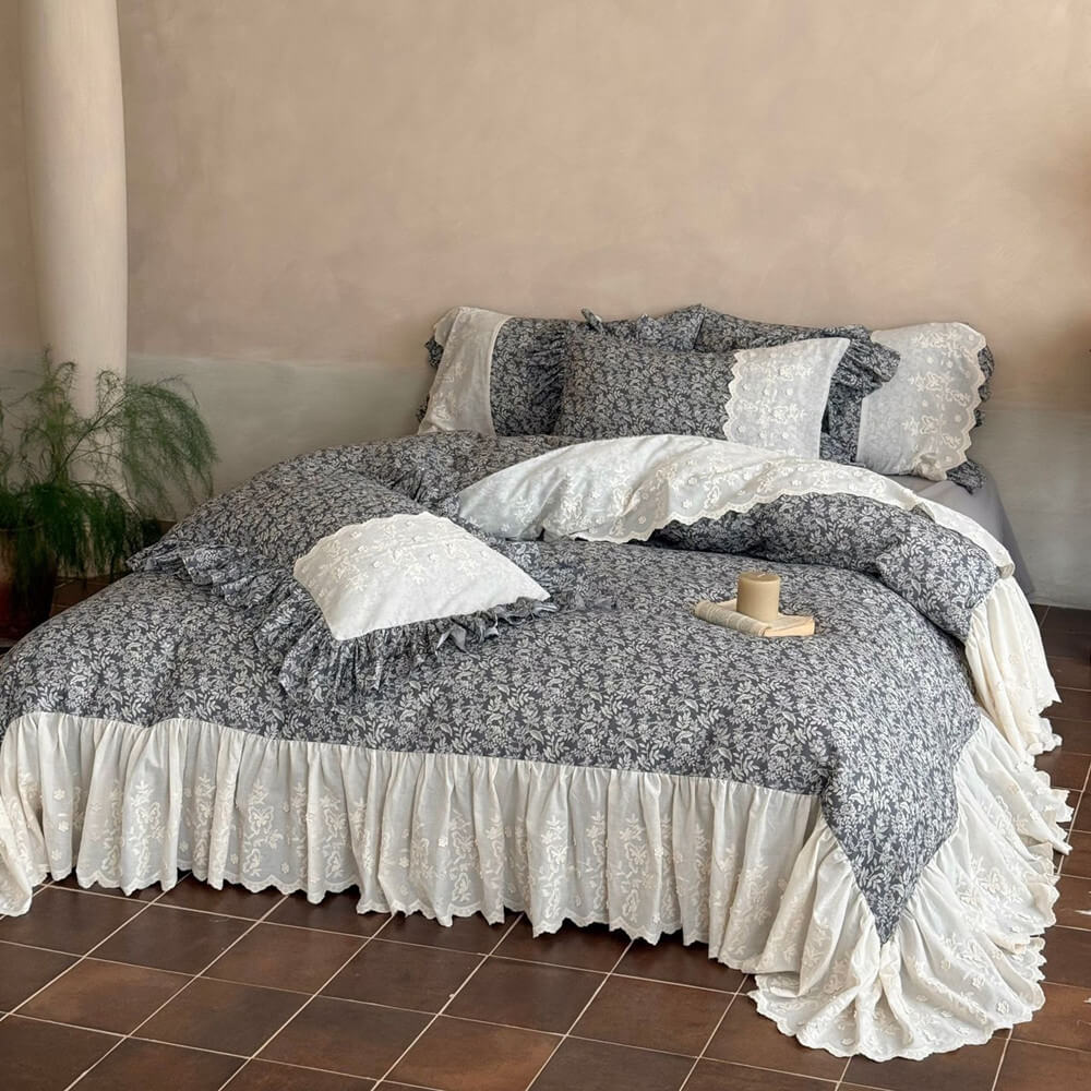 Full bed view of gray botanical ruffle bedding set with ivory embroidered accents
