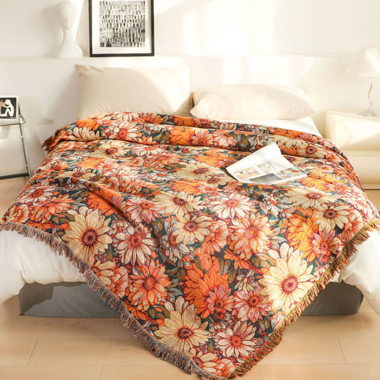 Daisy floral cotton throw blanket with fringe styled on a white bed