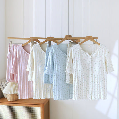 Women’s ditsy floral cotton short sleeve pajama sets in pastel colors hanging on wooden hangers