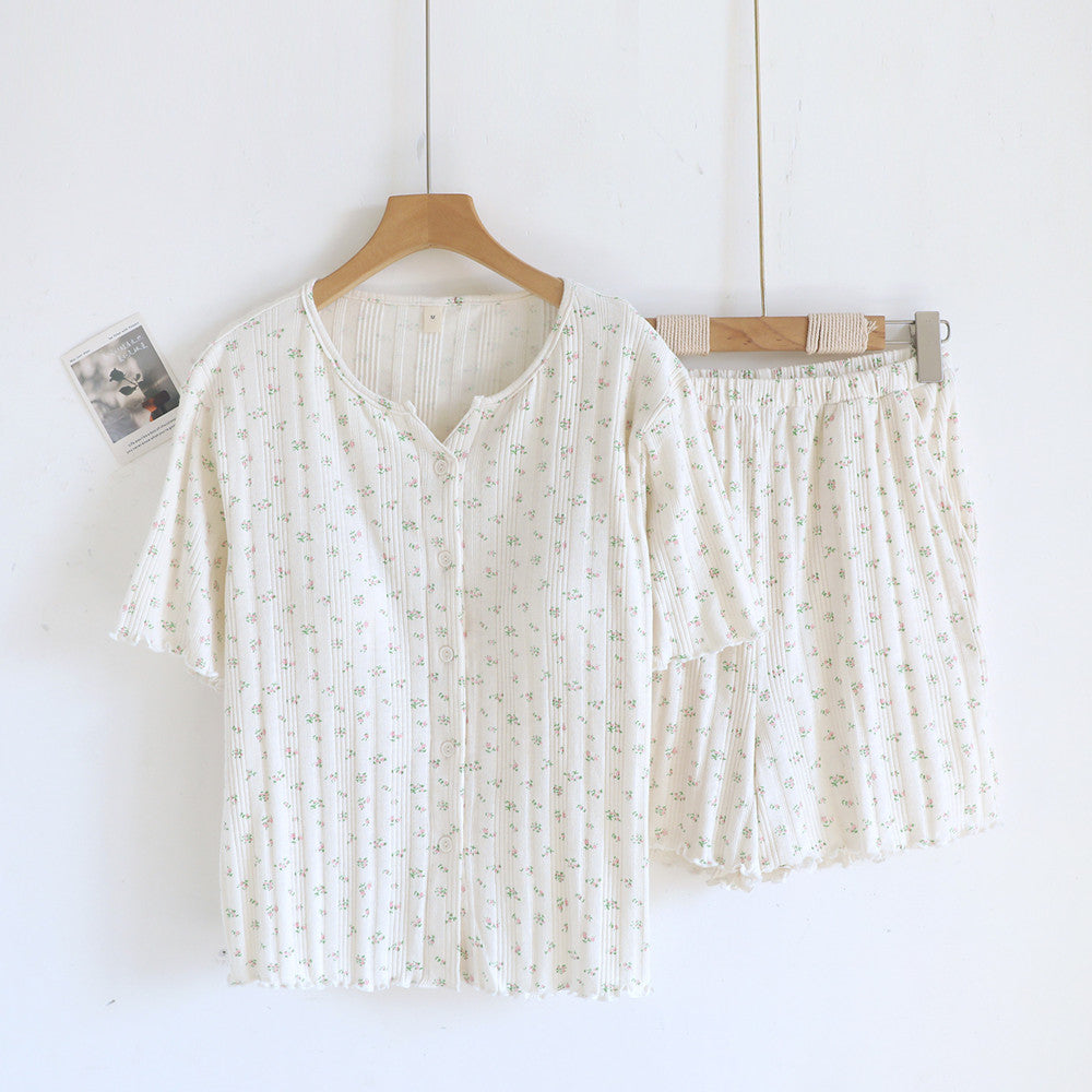 White cotton short sleeve pajama set with ditsy floral print, top and shorts on hangers