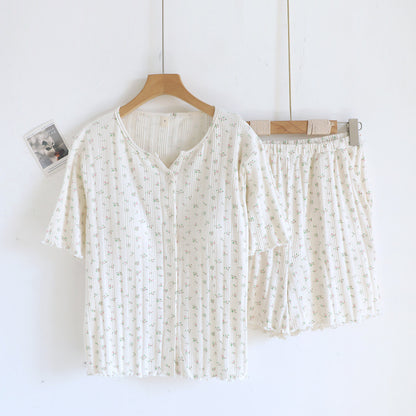 White cotton short sleeve pajama set with ditsy floral print, top and shorts on hangers