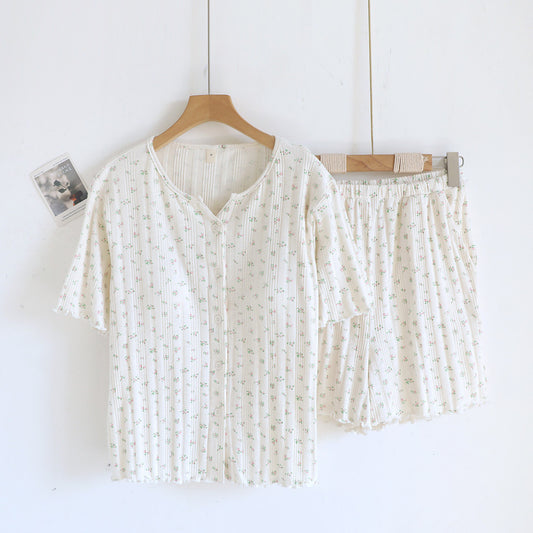 White cotton short sleeve pajama set with ditsy floral print, top and shorts on hangers