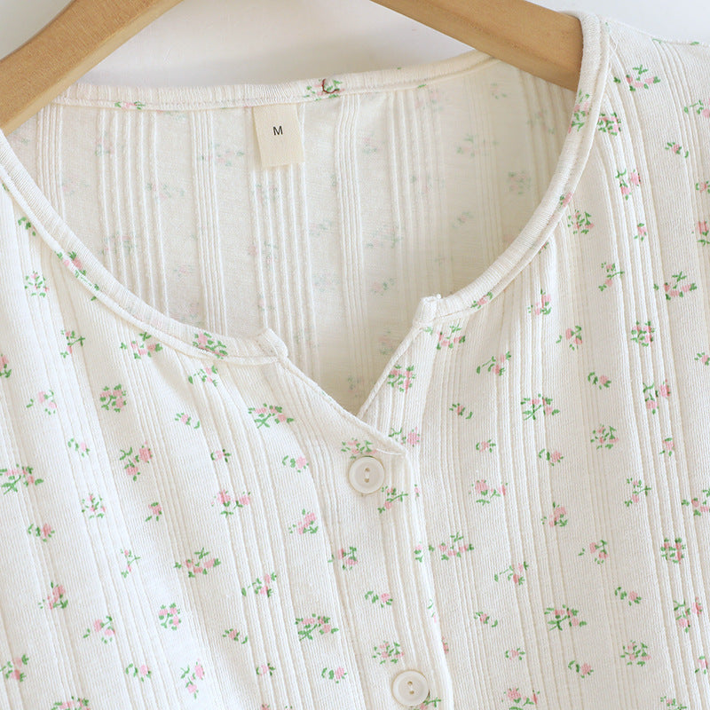 White cotton pajama top with ditsy floral print, short sleeves, and front buttons on hanger
