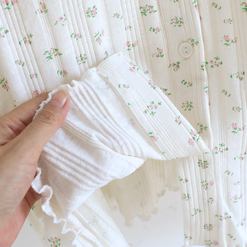 Close-up of white cotton pajama set with pink ditsy floral print and button detail