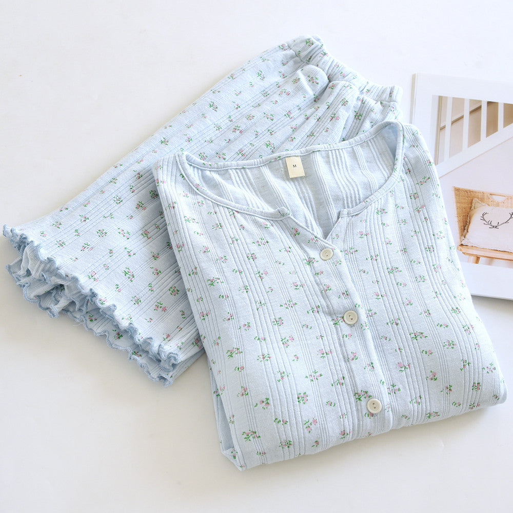 Light blue ditsy floral cotton short sleeve pajama set with ruffled trim, folded on white background