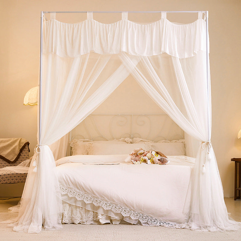 Elegant white canopy bed with sheer curtains, natural cotton bedding, cozy bedroom decor