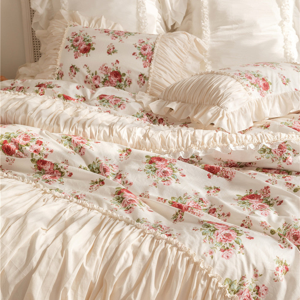 Floral cotton bedding set with ruffles and pink rose pattern on a cozy bed
