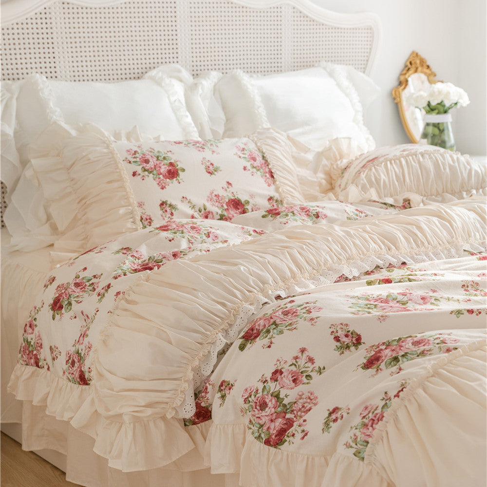 Floral cotton bedding set with ruffles and bed skirt on a white bed in a cozy bedroom