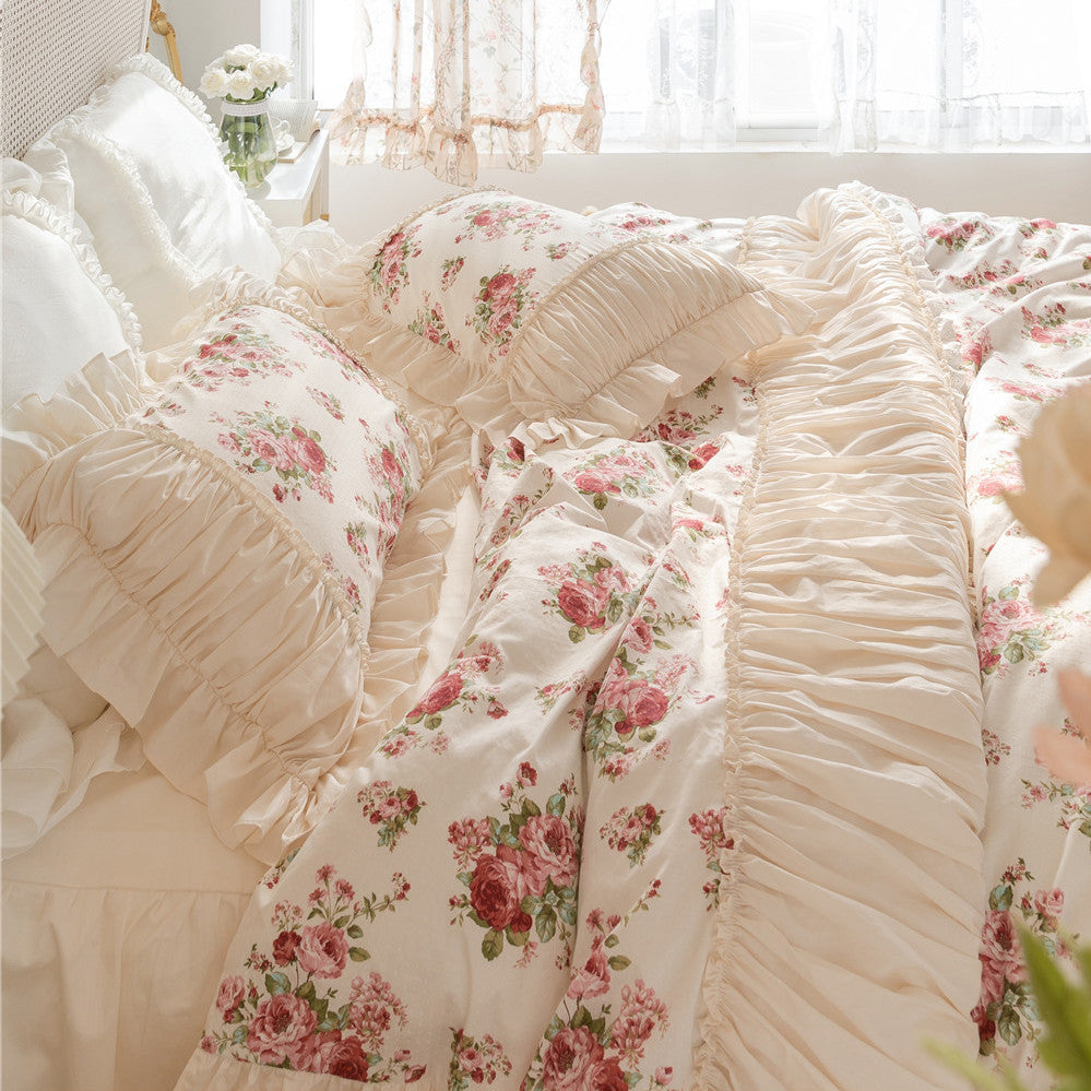 Floral cotton bedding set with ruffles and bed skirt in a sunlit, cozy bedroom.