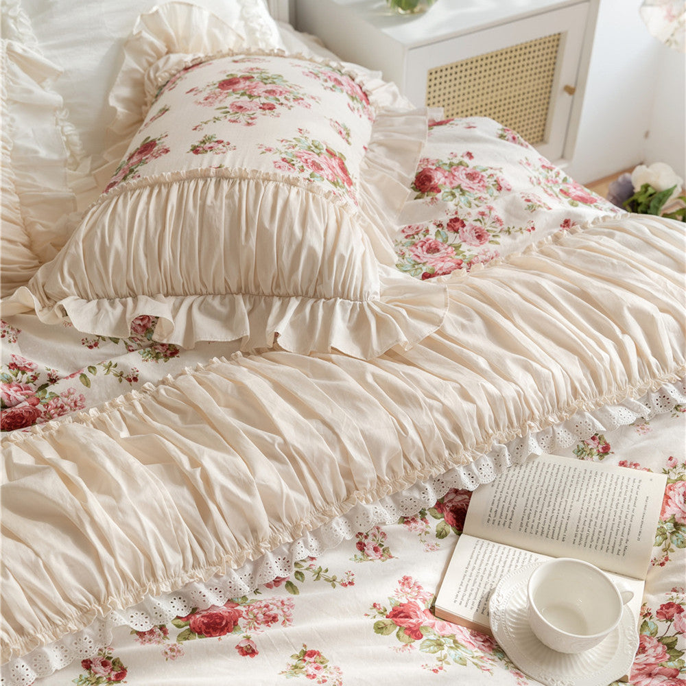 Floral cotton bedding set with ruffles and lace trim, cozy bedroom setting with book and teacup.
