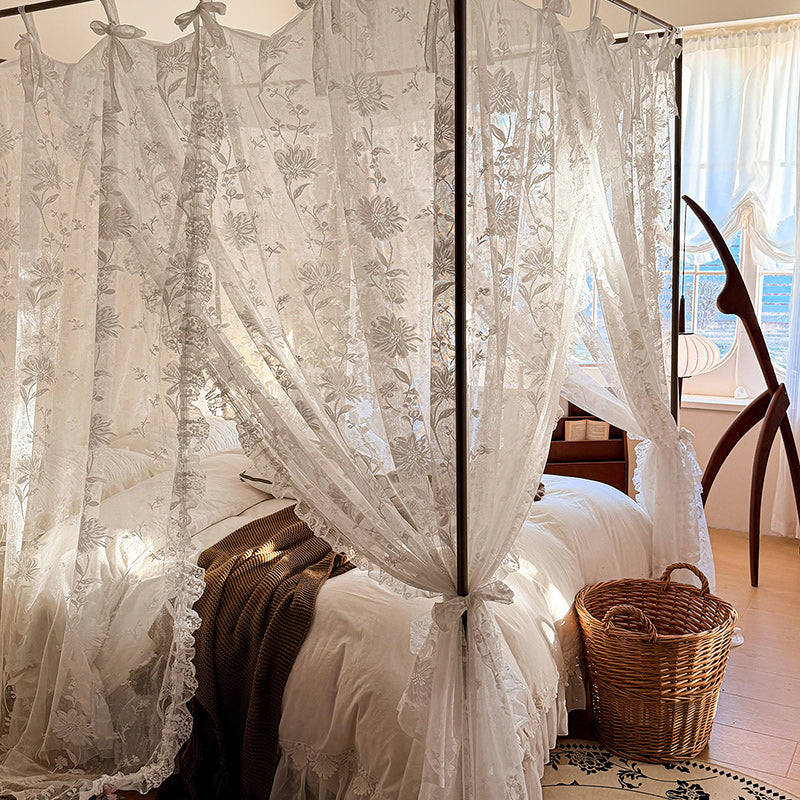 Elegant floral lace canopy curtains on a four-poster bed in a cozy sunlit bedroom