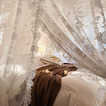 lace canopy curtains tied around bed post