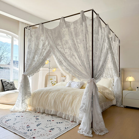 Floral lace canopy curtains on a four-poster bed in a bright, elegant bedroom