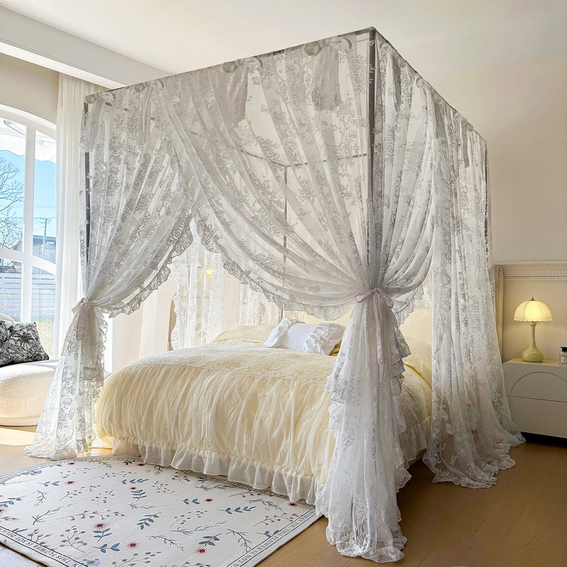 Elegant bedroom with floral lace canopy curtains on a four-poster bed and soft yellow bedding