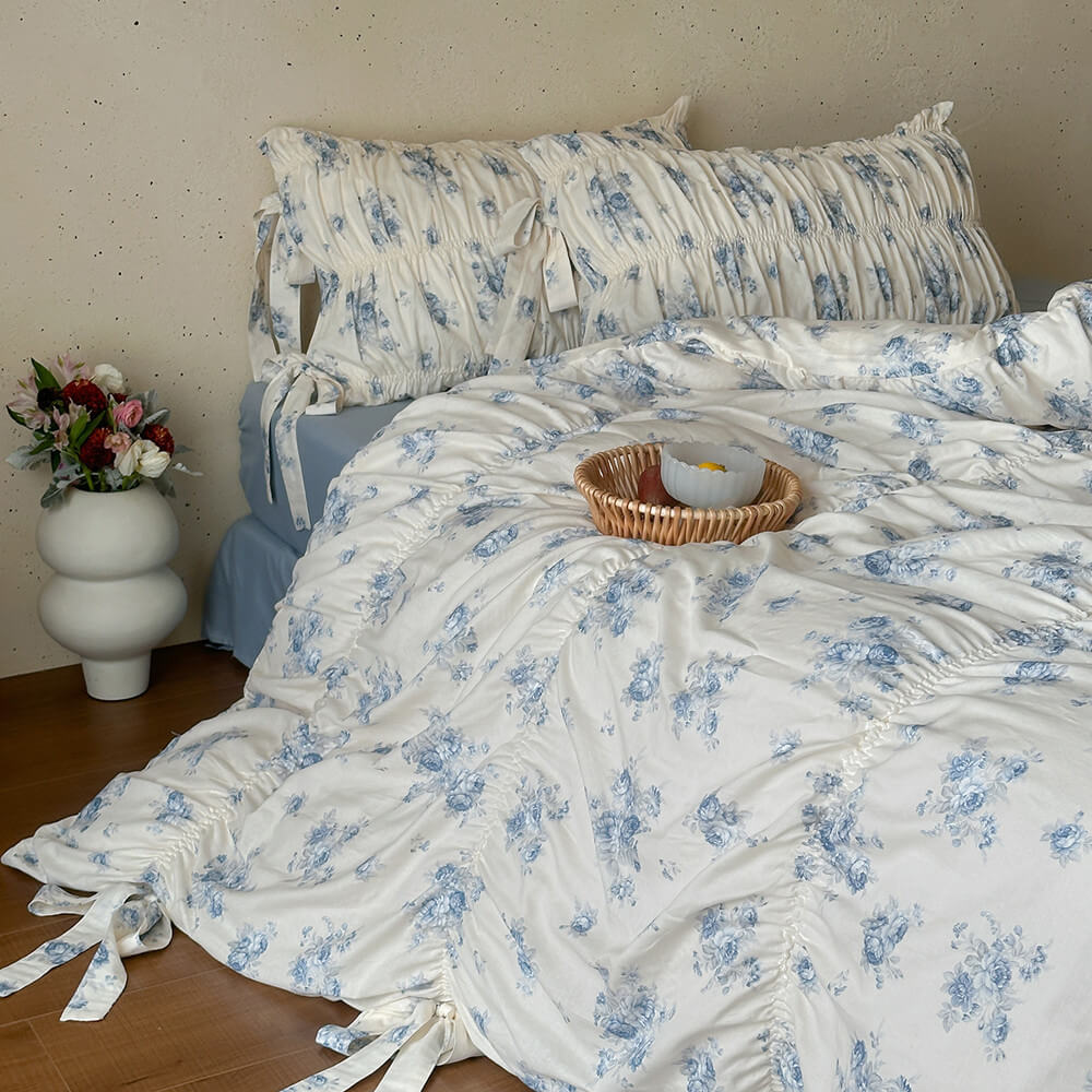 Vintage blue floral bedding with ruched detailing and ribbon tie pillowcases