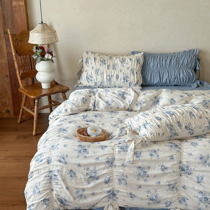 Gathered blue floral duvet cover set with ribbon tie bolster pillow detail