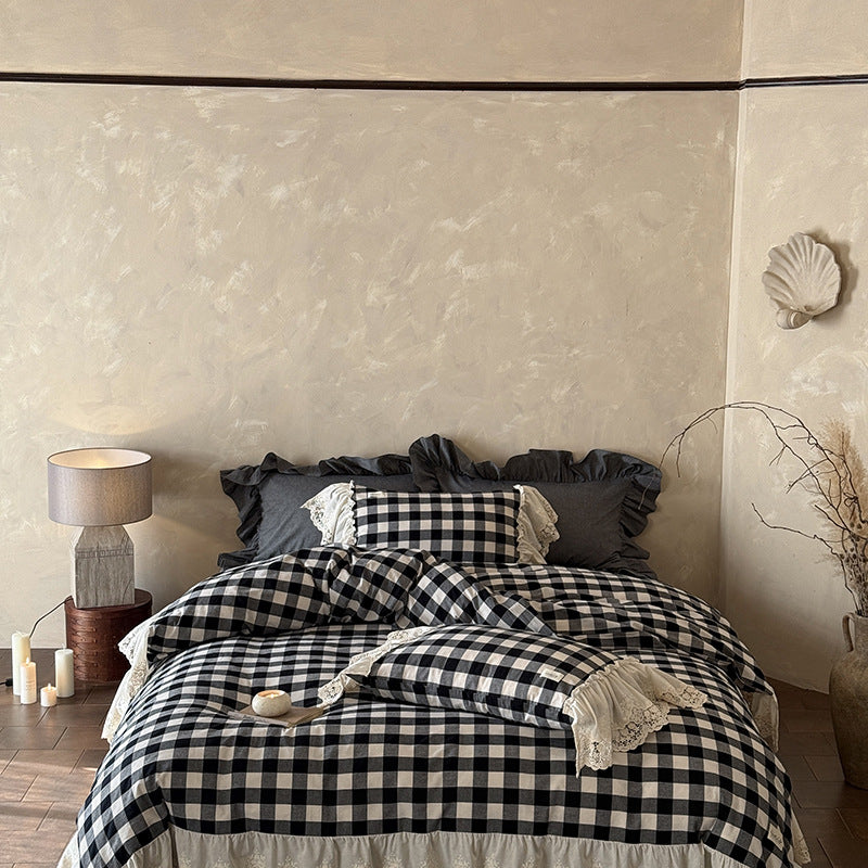 Bed with black and white checkered bedding in a bedroom setting.