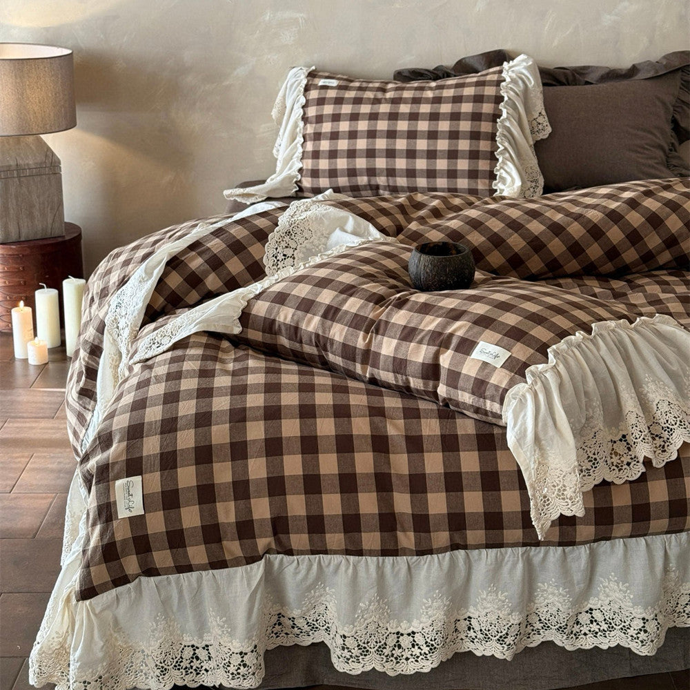Bed with brown checkered duvet and lace trim in a bedroom setting.