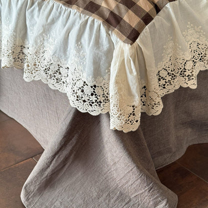 Close-up of a lace-trimmed tablecloth on a wooden surface