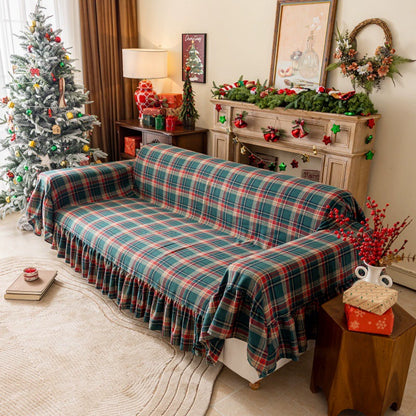 Green tartan plaid Christmas sofa cover with ruffles in a festive living room setting