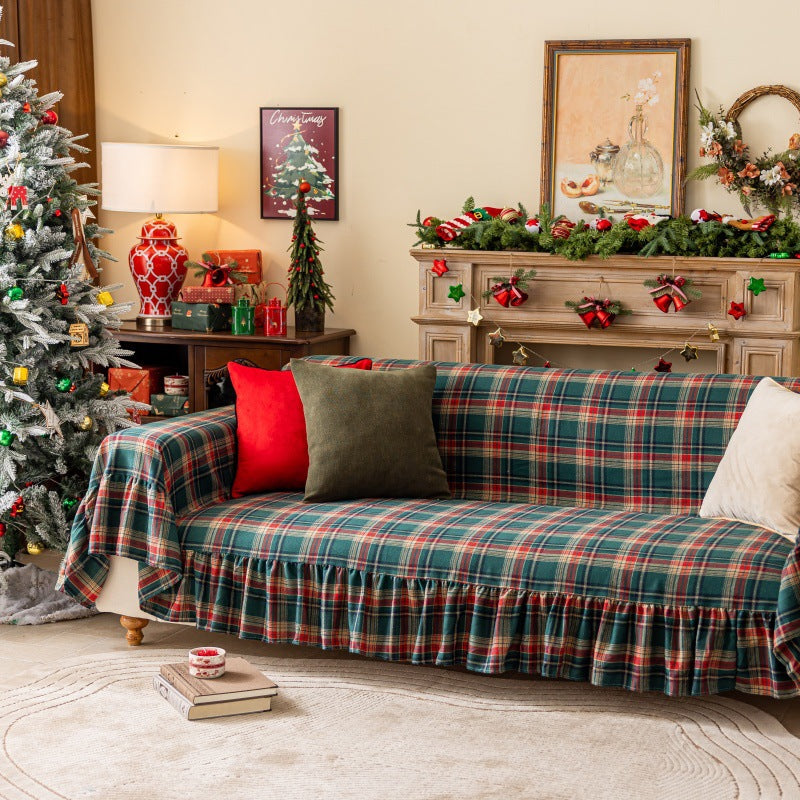Green tartan plaid Christmas sofa cover with ruffles in festive holiday living room decor