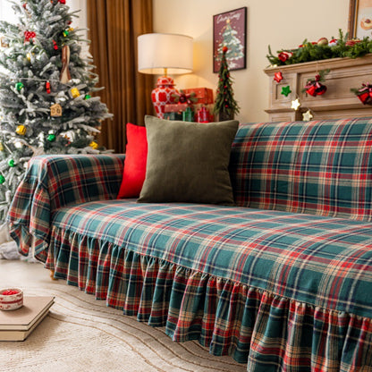 Green tartan plaid Christmas sofa cover with ruffles in festive living room decor
