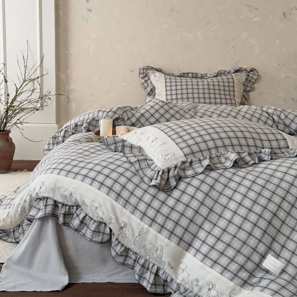 Grey plaid cotton muslin bedding set with ruffled trim and embroidered animal details