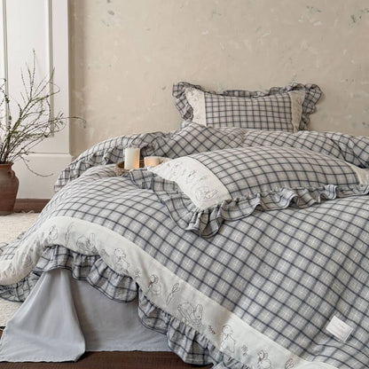 Grey plaid cotton muslin bedding set with ruffled trim and embroidered animal details