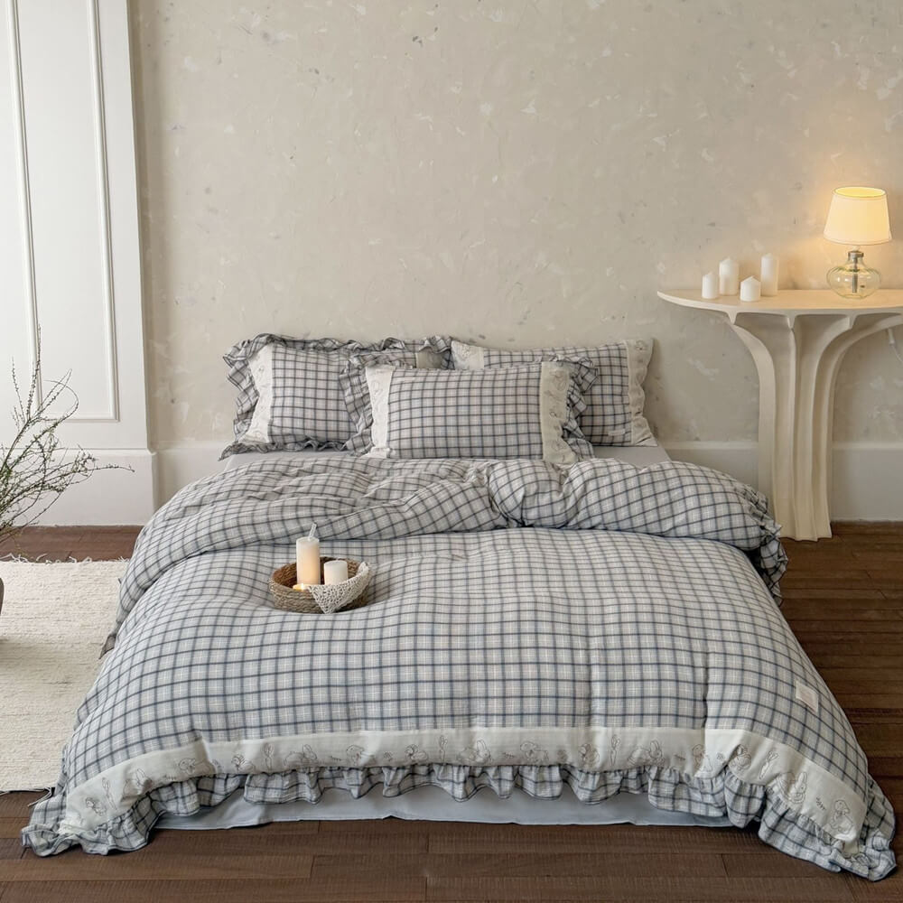 Grey plaid cotton muslin bedding set with ruffled trim on a bed, cozy bedroom decor from StuffedHome
