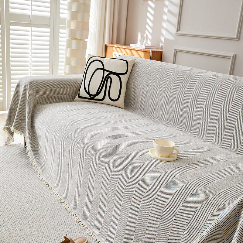 Herringbone chenille sofa cover with modern pillow in a bright living room, sustainable home decor