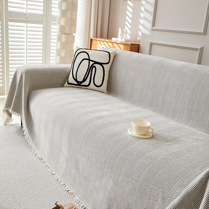 Herringbone chenille sofa cover with modern pillow in a bright living room, sustainable home decor
