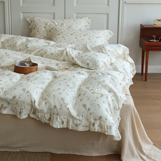  Cotton gauze duvet cover set with hot air balloon and moon print. Features ruffled trim on the duvet and pillow shams.