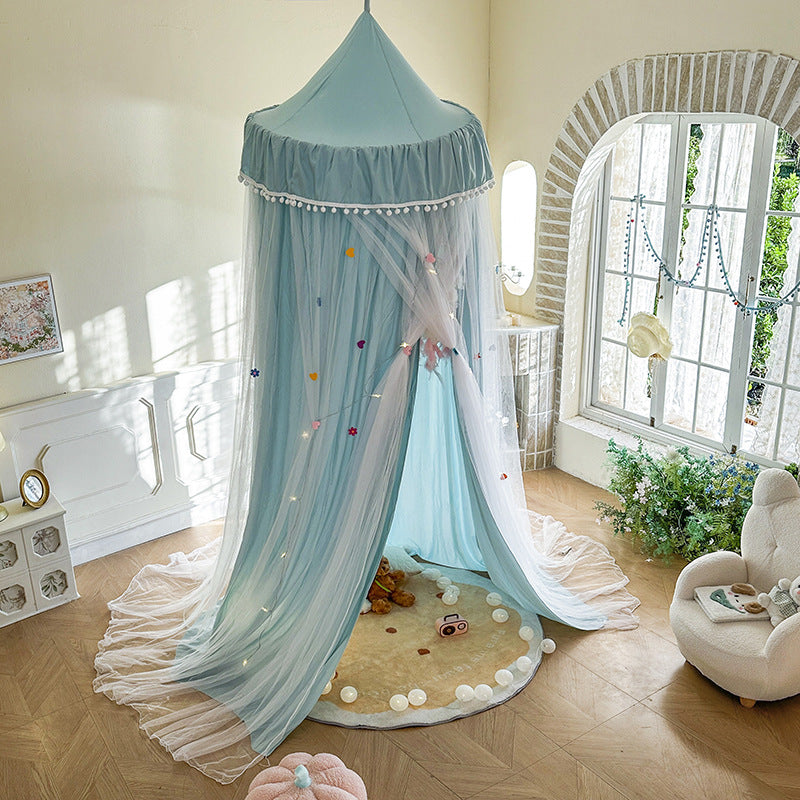 Blue kids bed canopy tent in cozy decorated bedroom with plush toys and pastel decor