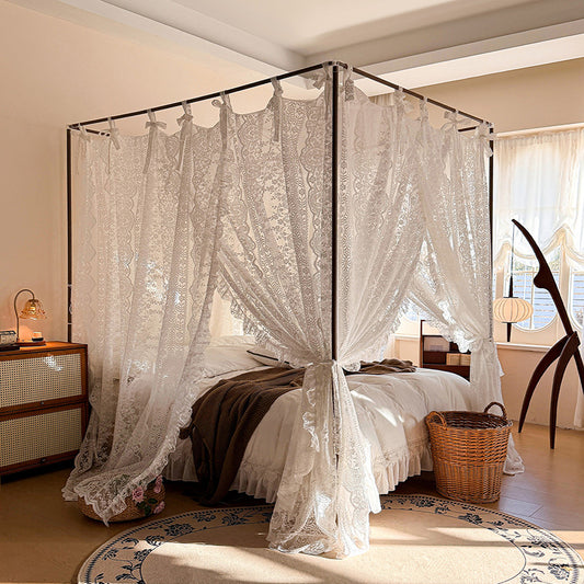 Lace bed canopy curtains on a four-poster bed in a cozy, sunlit bedroom