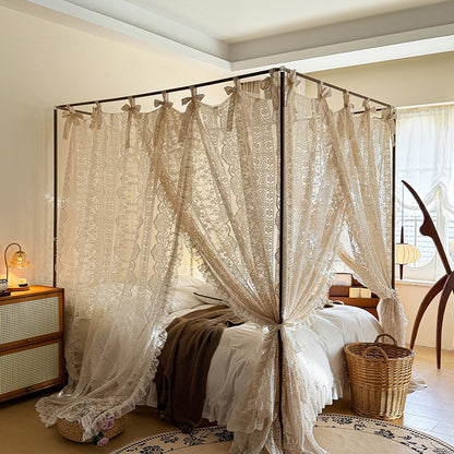 Elegant lace bed canopy curtains on a four poster bed in a cozy, sunlit bedroom.