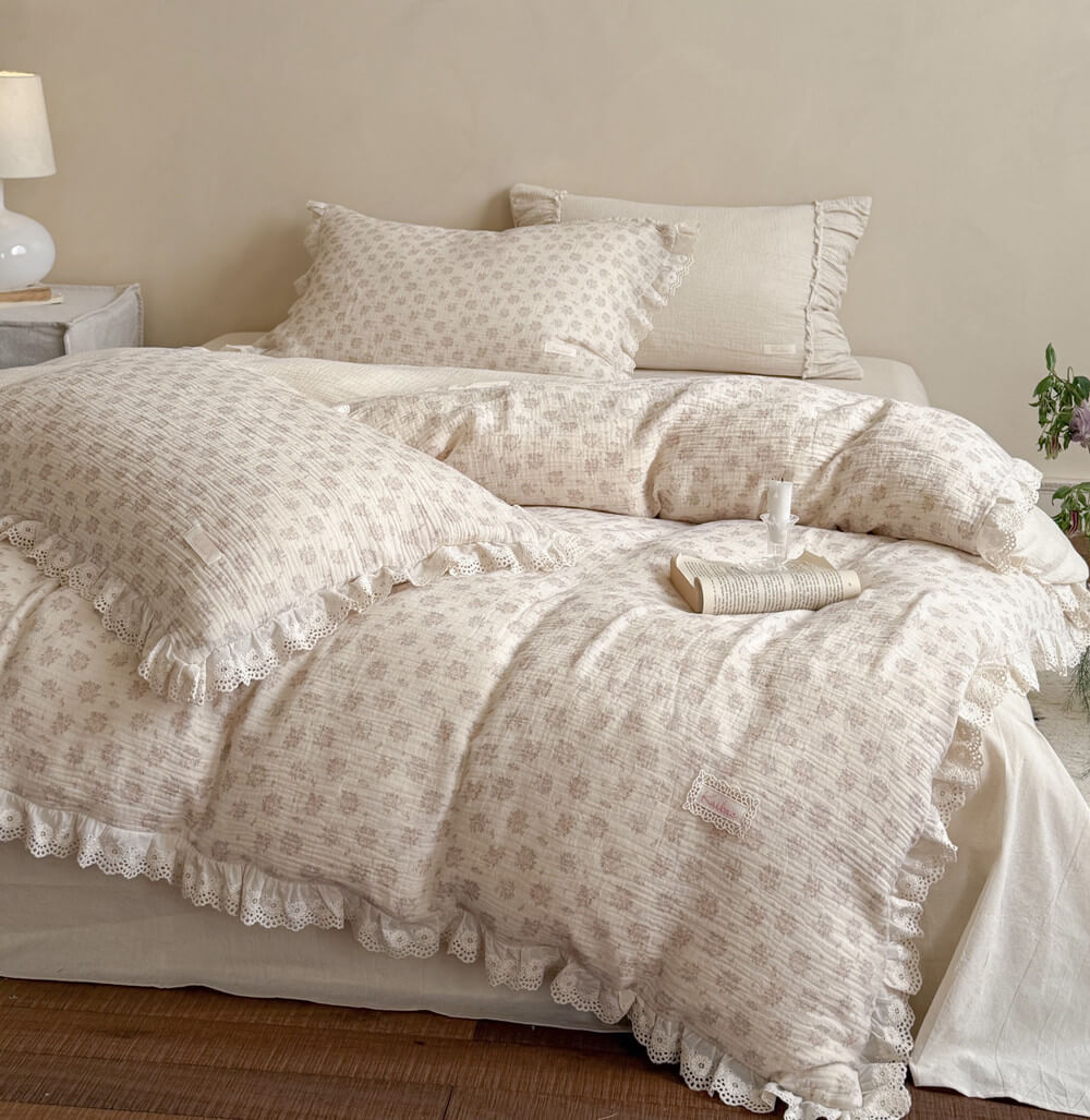Cottagecore dusty pink floral bedding set made of premium cotton linen blend, featuring elegant lace ruffle edges on a beautifully styled farm-house bed.