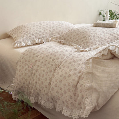 Side view of luxurious French cottage style bedding with crinkled cotton-linen fabric texture, dainty floral prints, and scalloped lace edge ruffles.
