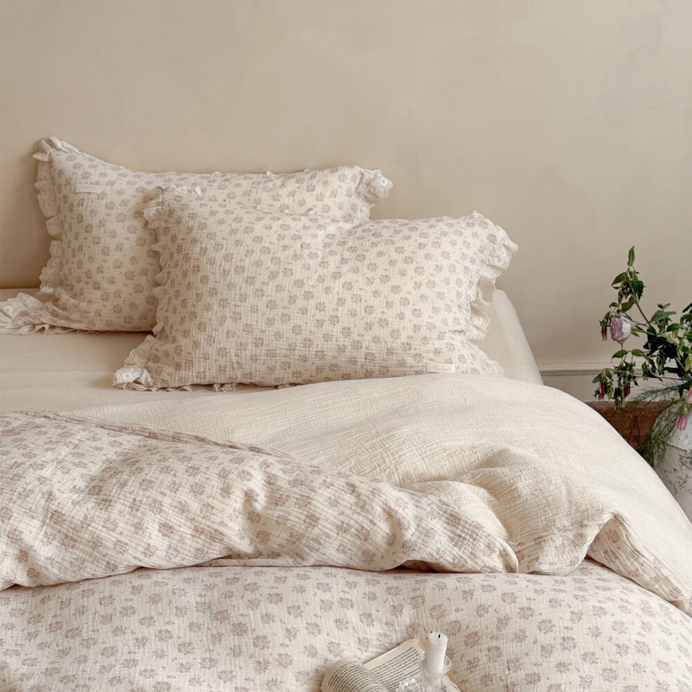 Shabby chic style matching floral pillowcases and folded duvet cover highlighting the breathable, high-quality linen-cotton crinkle texture.