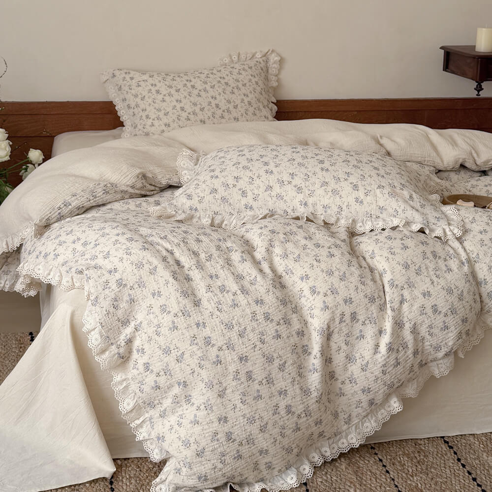 Blue rose cotton linen bedding set with lace ruffle trim styled on a vintage cottage bed
